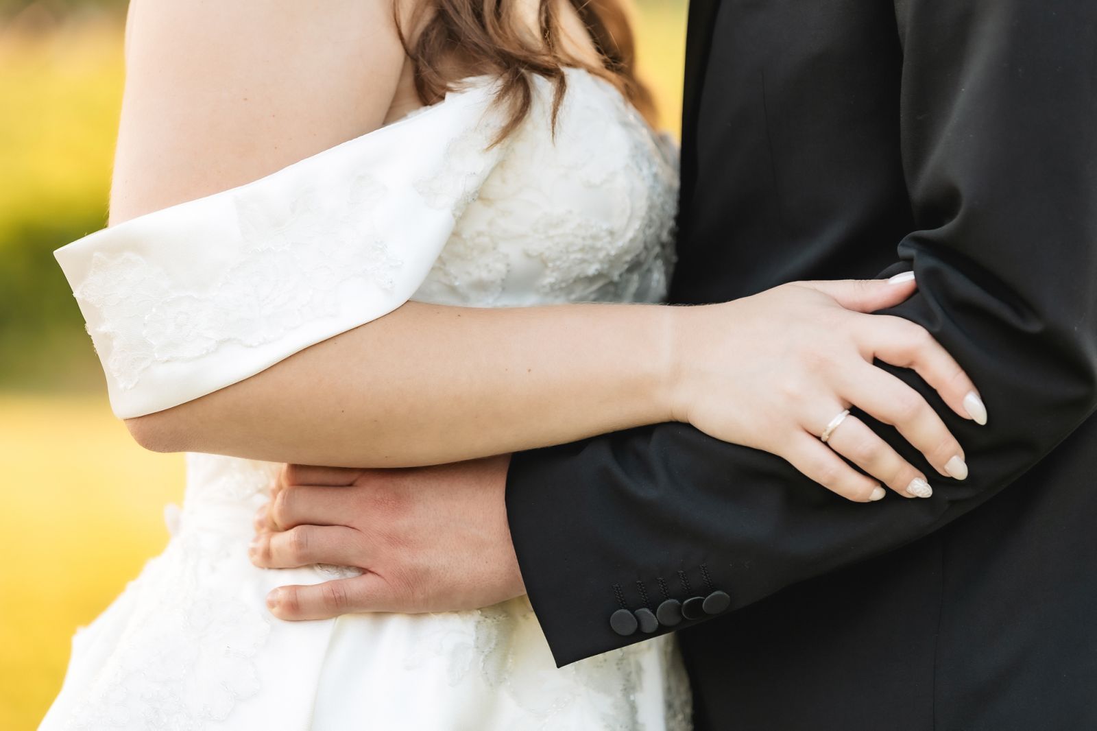 Close-up of bride and groom embracing